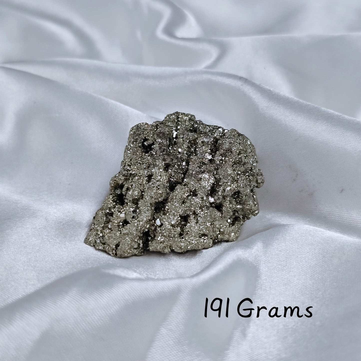 Energised Pyrite Rough placed on a wooden display for décor and energy