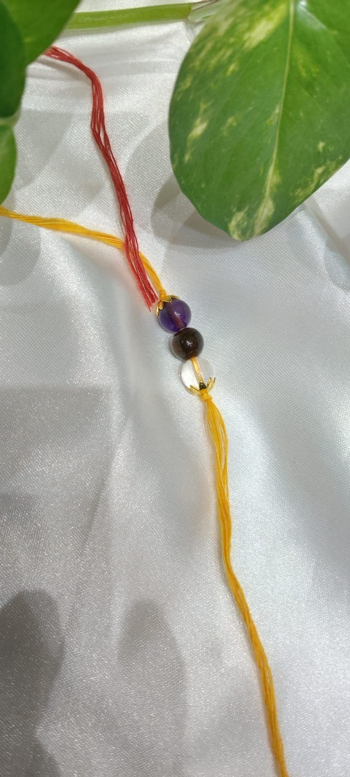 THE GEMZ Trinity Thread Rakhi with Clear Quartz, Tiger Eye and Amethyst for energy alignment and spiritual balance in India