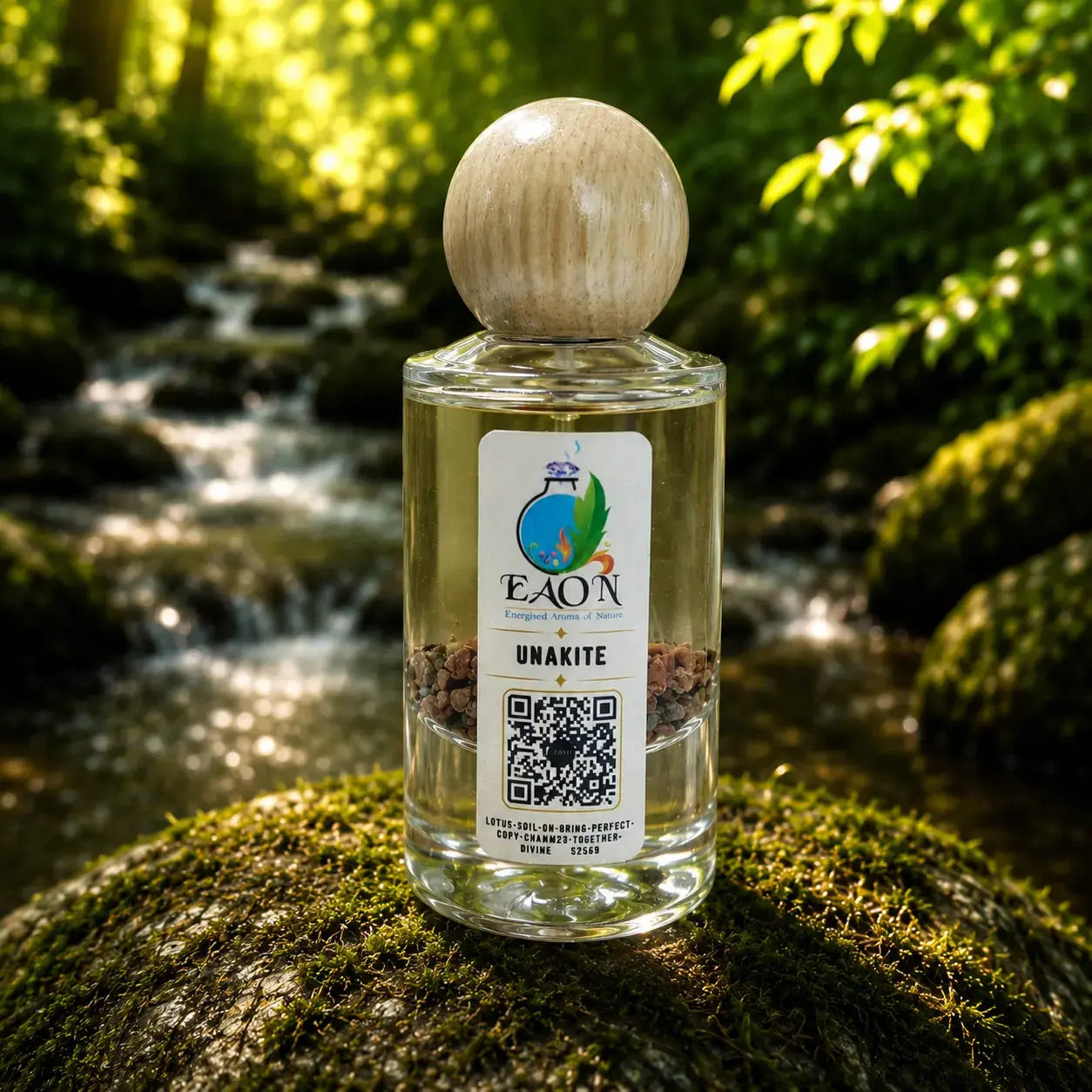 Bottle of EAN Unakite Eaon Perfume on a mossy rock with a natural background