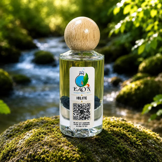 Bottle of EAON Iolite essential oil on a mossy rock with a natural background