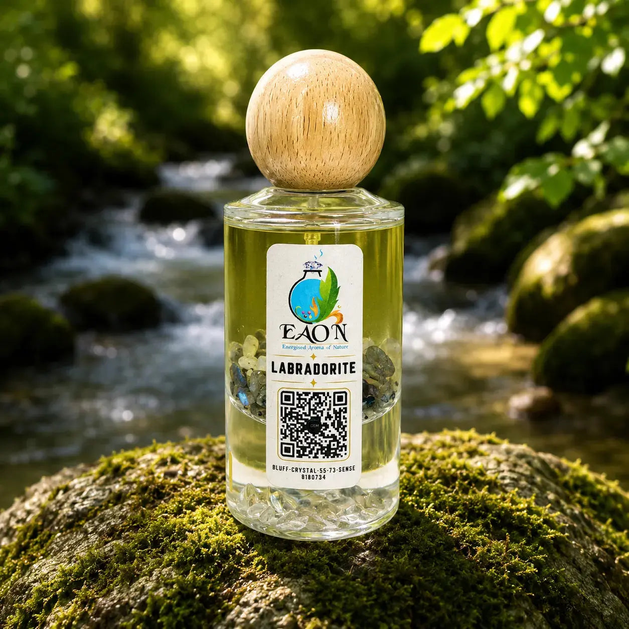 Bottle of EAON Labradorite Eaon Perfume on a mossy rock with a natural background