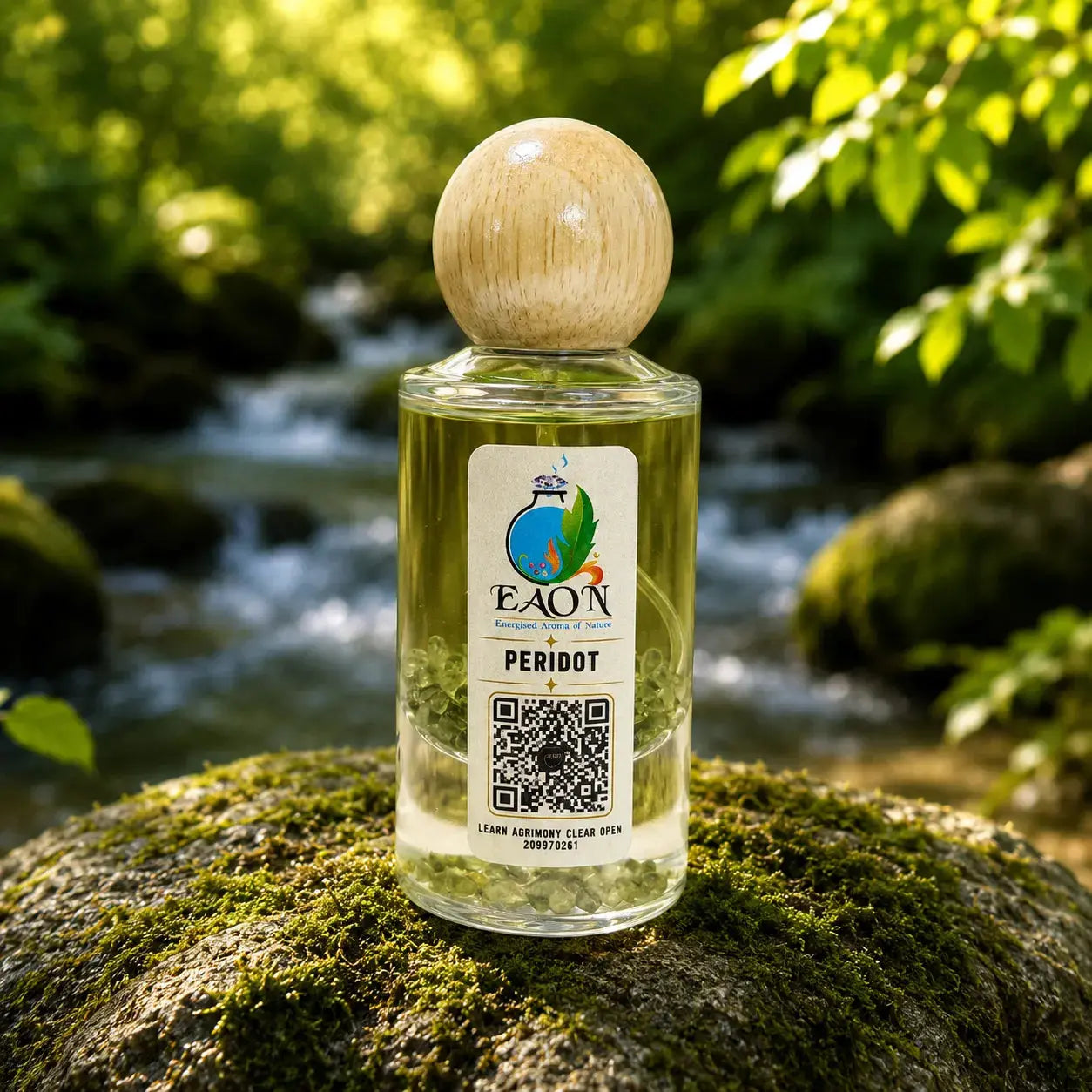 Bottle of EAON Peridot essential oil  Eaon Perfume on a mossy rock with a natural background