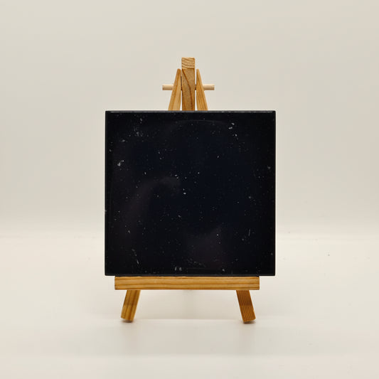 Polished black onyx gemstone tile close-up texture