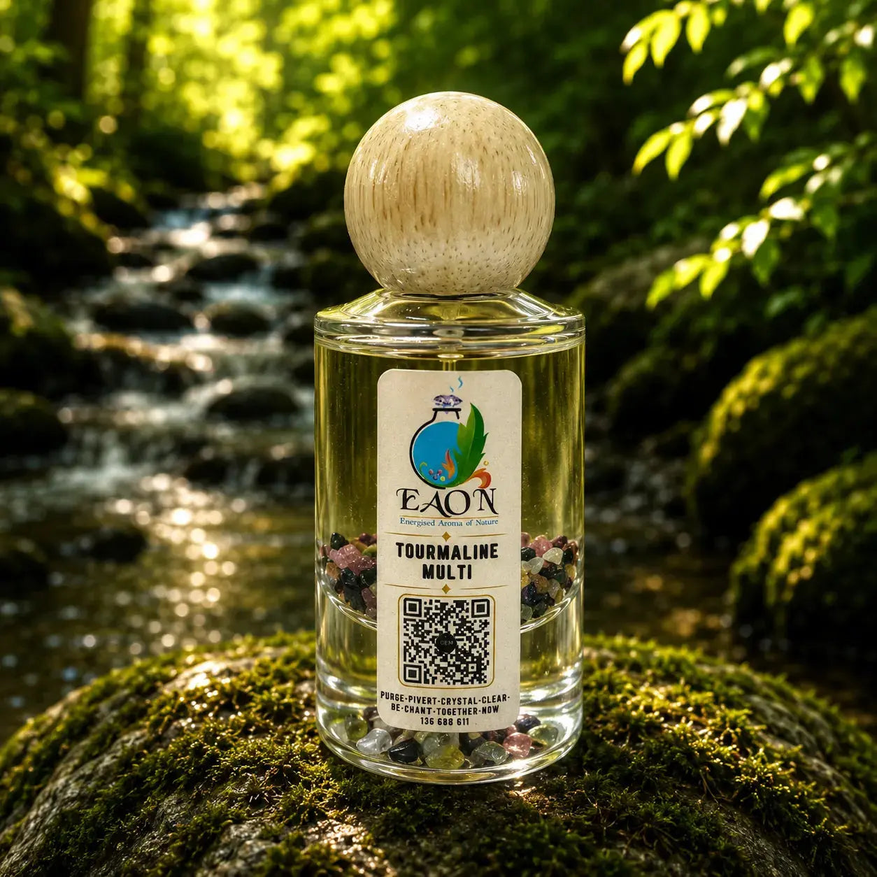 EAON bottle of Tourmaline Multi Eaon Perfume on a mossy rock with a forest background